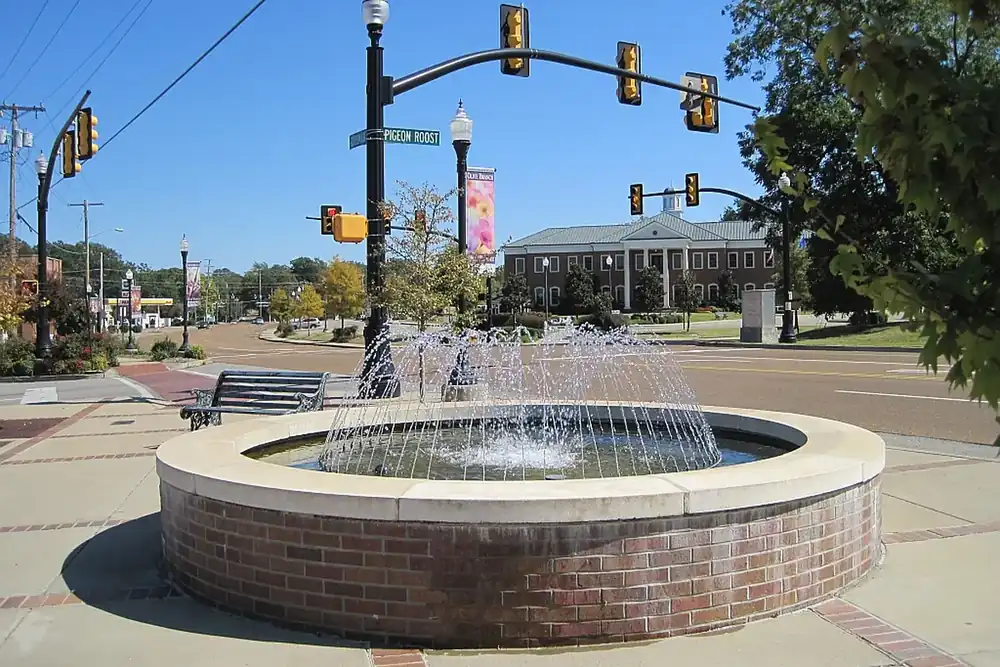 Brick fountain at Pigeon Roost Road with Olive Branch City Hall behind it in Olive Branch, Mississippi