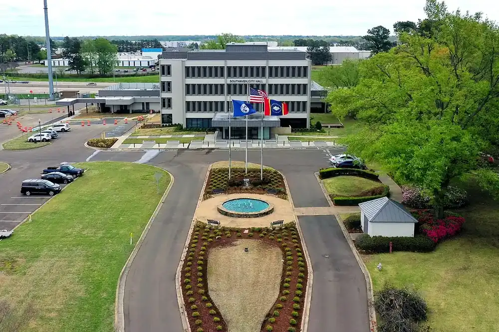 Aerial view of Southaven City Hall with flags, a fountain and landscaped drive in Southaven, Mississippi