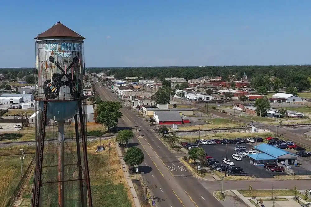 Aerial view of downtown West Memphis, Arkansas, with the city's painted water tower in the foreground